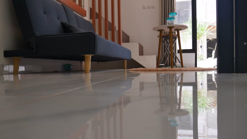A sleek, modern interior space featuring a smooth, high-gloss epoxy floor in a neutral grey tone